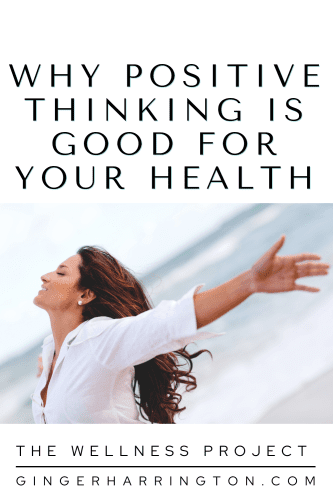 Woman beside ocean has hands back with joyful look is an example of positive thinking. 