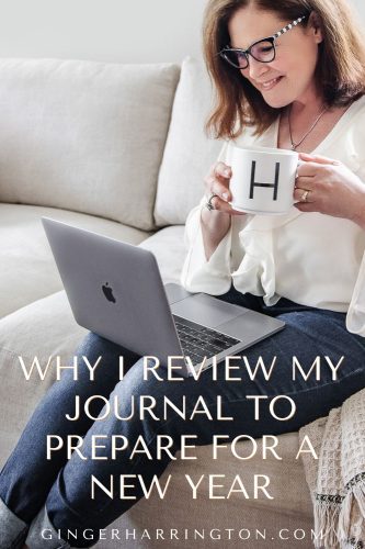 Woman with mug reviews laptop