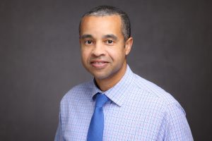 Headshot of man in blue shirt, Keon Lindsey.