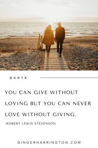 Couple walking wooden path to beach illustrates a short quote on love.