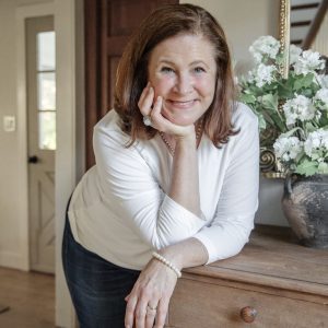 Christian author and speaker Ginger Harrington smiles at camera in a lifestyle shot.