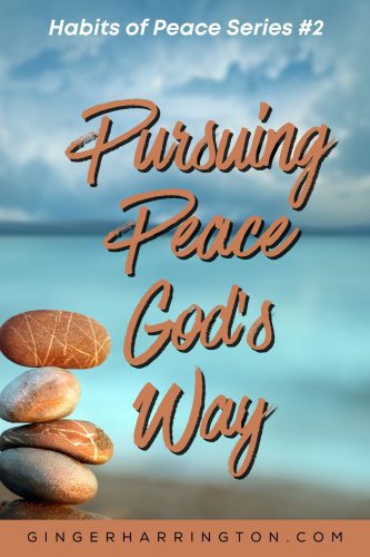 Pebbles are stacked with ocean in background for post on pursuing peace.